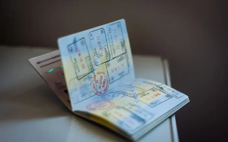 Open passport with travel stamps for tourist visa assistance